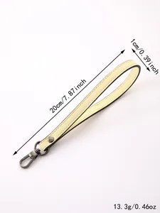 Detailed view of cream leather wristlet strap with measurements and metal lobster clasp.