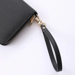 Elegant black Saffiano leather wrist strap featuring a golden metal lobster clasp for wallets