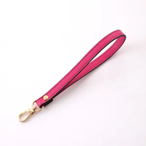 Elegant fuchsia leather wristlet strap featuring a durable gold lobster clasp for handbags