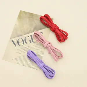 Close-up view of three-strand braided PU leather ropes in red, pink, and purple