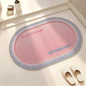 Oval pink absorbent bathroom mat with non-slip texture and striped border design