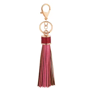 Elegant pink leather tassel keychain with gold lobster clasp on white background