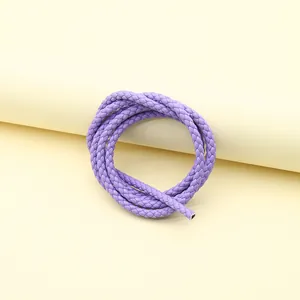 Macro view showing the detailed texture of purple three-strand braided PU leather rope