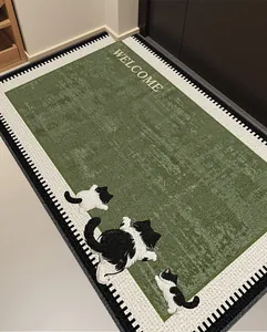 Detailed view of loop pile door mat featuring green center and cute kitten patterns.