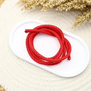 Close-up detail of a red three-strand braided PU leather cord for craft accessories.