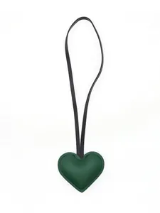 Detailed view of the dark green leather heart charm with matching black strap