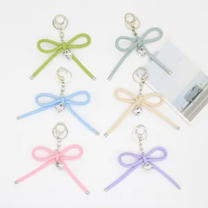 Detail of minimalist leather rope bow keychains in various pastel colors