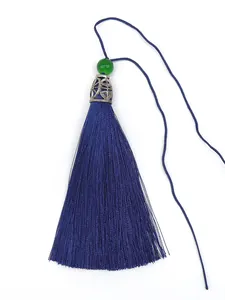 Close-up of a dark blue polyester tassel featuring a green bead and silver metal cap