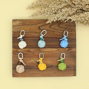 Detail view of handmade woven PU leather ball keychains in six vibrant colors.