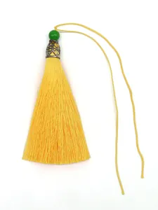 Detailed view of a bright yellow polyester tassel with a green bead and metal cap