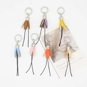 Detailed view of seven colorful handmade PU leather tassel charms for bags and shoes