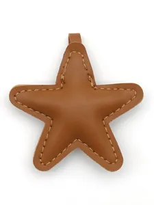 Close-up of a brown padded leather star-shaped charm with visible yellow stitching.