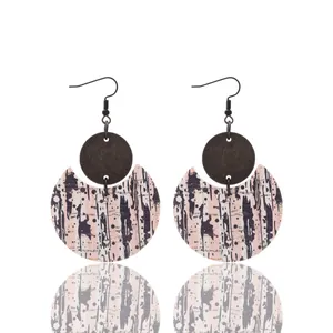 Elegant crescent shaped leather and wood drop earrings featuring abstract splatter patterns.