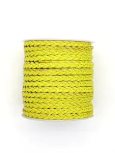 Detail view of fluorescent yellow 3-strand braided PU leather cord on a white spool.