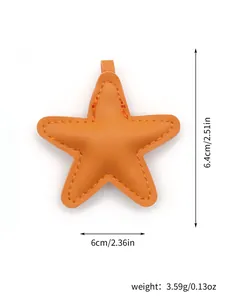 Detail view of an orange leather star bag charm showing its dimensions and weight.