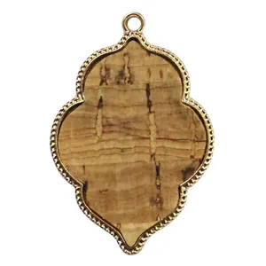 Detailed view of vintage gold quatrefoil pendant with natural bark texture insert