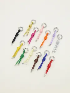 Detailed view showing a variety of colorful handmade knotted PU leather tassel charms