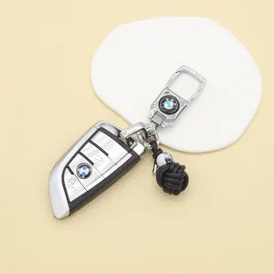 Detailed view of handmade black PU woven ball keychain with silver clasp