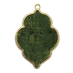Close-up macro view of retro green natural stone pendant with gold scalloped alloy edge