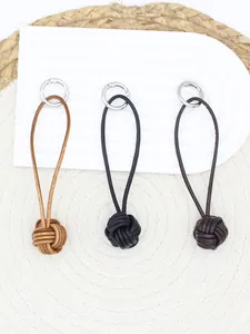 Set of three handmade retro leather monkey's fist knot keychains in brown and black colors