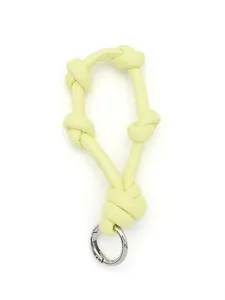 Macro view of a lime green knotted leather keychain lanyard with silver spring ring.