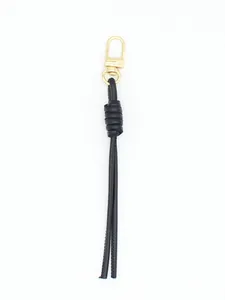 Close-up of black PU leather braided keychain with a gold-tone lobster clasp detail