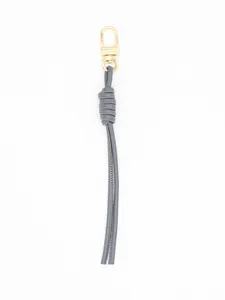 Detailed macro view of a stylish grey handmade woven PU leather keychain with a gold clasp