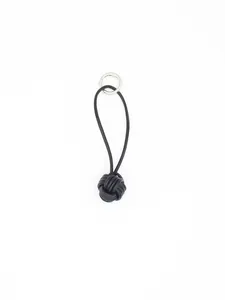 Macro view of handcrafted black leather monkey fist knot on a minimalist keychain