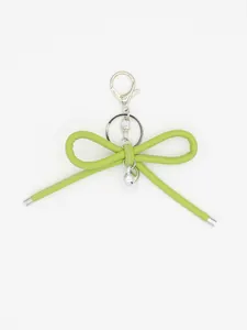 Detail view of a lime green leather bow keychain with silver heart charm and lobster clasp.