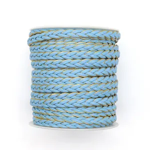 Braided light blue and gold PU leather cord on white spool for DIY jewelry crafts