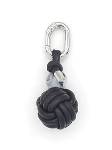 Close-up of handmade black PU woven ball keychain with marble bead and silver clasp