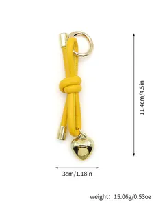 Detailed view of yellow leather cord keychain with gold heart charm and dimensions