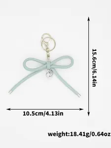 Detail view of light blue woven leather bow keychain with size and weight marks