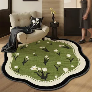 French vintage green floral irregular rug styled in a modern cozy living room setting