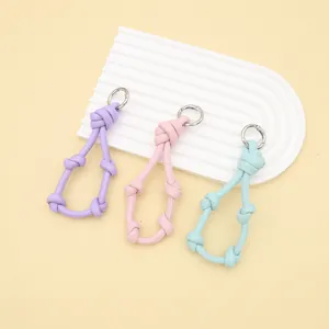 Pastel braided leather knotted keychains and phone charms in purple, pink, and blue