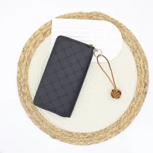 Retro handmade leather monkey fist knot keychain with minimalist black geometric wallet.