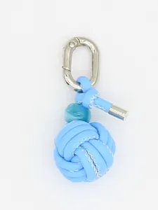 Detail of handmade woven PU leather ball keychain charm in light blue with silver clasp