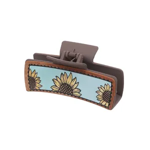 Haarklammer aus Leder im Western-Stil mit Sonnenblumenmuster auf blauem Grund