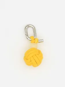 Detailed view of a handmade yellow woven PU sphere keychain with silver clasp