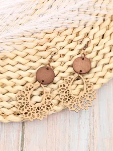 Close-up of Bohemian hollow wooden earrings featuring intricate laser-cut floral patterns