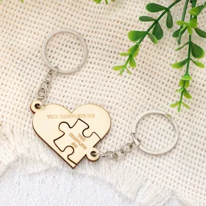 Close-up detail of interlocking wooden heart puzzle keychains with custom engraving