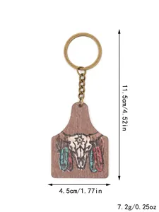 Detail view of Western farm style wooden keychain with cow skull print and dimensions.