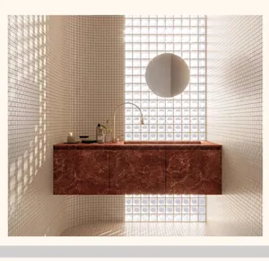 Interior view of a luxury bathroom featuring red marble floating vanity and gold faucet detail