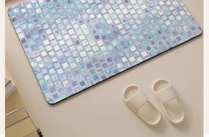 Detail view of iridescent mosaic diatom mud bath mat with matching beige slippers.