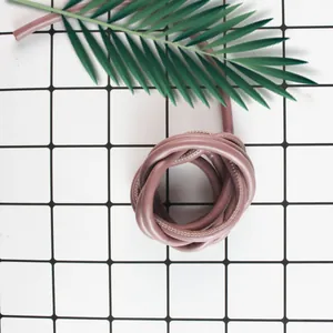 Macro view of durable mauve PU leather stitched cord for DIY bag weaving and phone lanyards