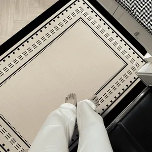 Tapis d'entrée minimaliste de luxe avec bordure géométrique et texture en velours