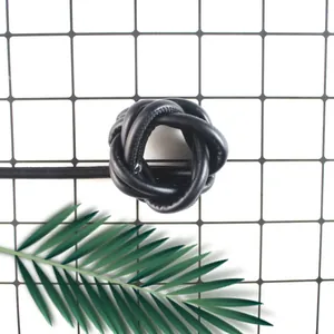 Macro detail of a knotted black PU leather rope with visible stitching for DIY crafts
