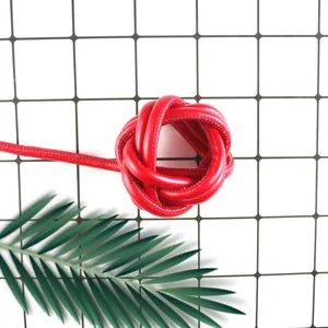 Detail of red PU leather cord knot showing fine stitching and smooth texture for DIY crafts.