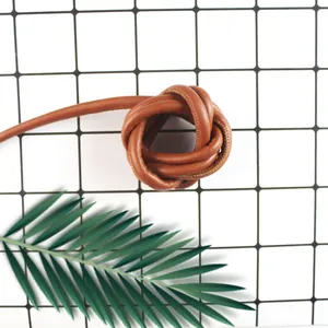 Detailed view of brown PU leather cord with fine stitching and core structure for DIY crafts