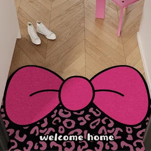 Paillasson rose en forme de nœud avec imprimé léopard et texte 'welcome home'